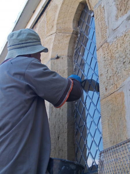 Gavin Merrington completing re-installation of an aisle window (Image: Brian Andrews)